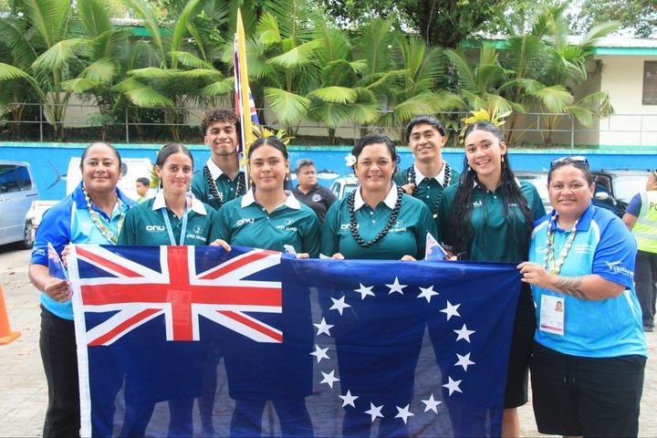 Team and officials with the Cook Islands flag