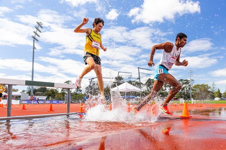 Steeplechasers splash through the water jump