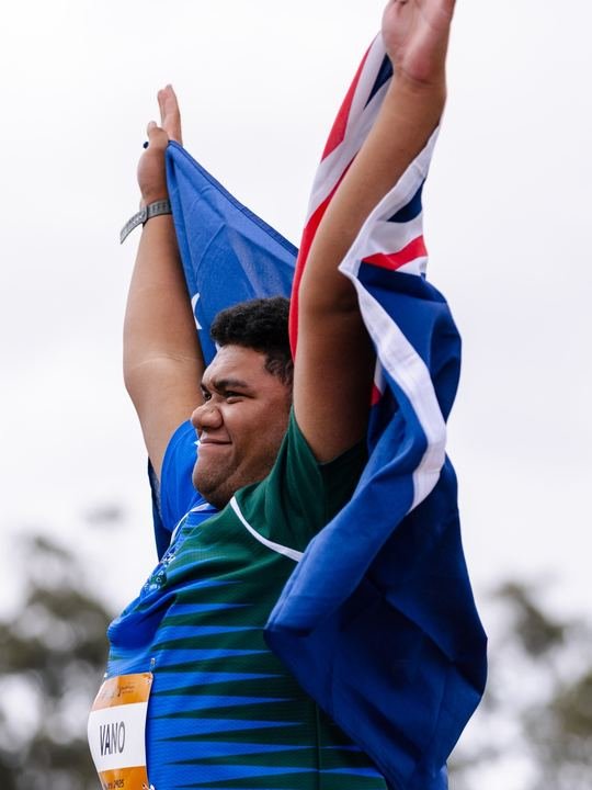 Arms up with the Cook Islands flag