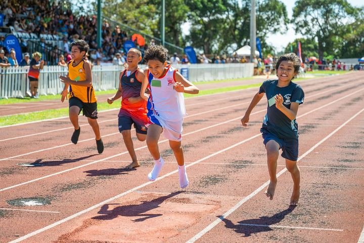 Sprinters drive for the line in front of a packed grandstand.