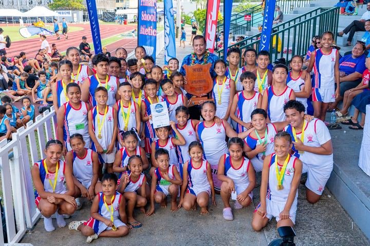 A school team with its shield, medals and certificates at prize-giving